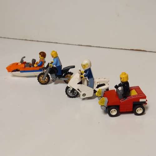 Four Lego Minifigurines And Lego Vehicles