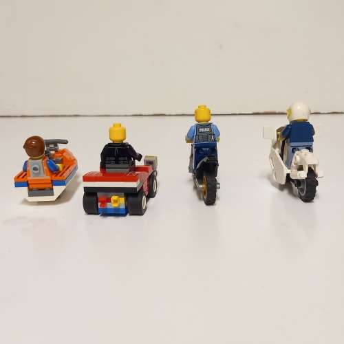Four Lego Minifigurines And Lego Vehicles