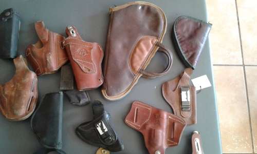 COLLECTION OF 28 PISTOL/ REVOLVER HOLSTERS. WIDE ASSORTMENT. ONE BID..