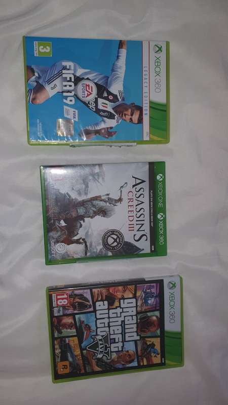 Xbox 360 Console, 2 Controllers, 3 Games( Grand Theft Auto V, FIFA 19, Assassin's Creed III).