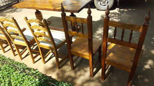 SOLID OAK JACOBEAN DINNING ROOM SET WITH LADDER BACK CHAIRS.
