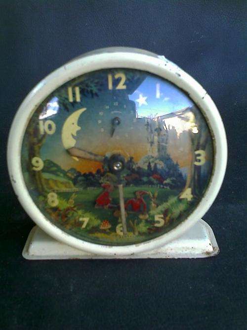 OLD ALARM CLOCK. CANNOT SEE WHERE IT IS MADE. 2 GOBLINS ON A TOADSTOOL. MARKED.NOT WORKING.