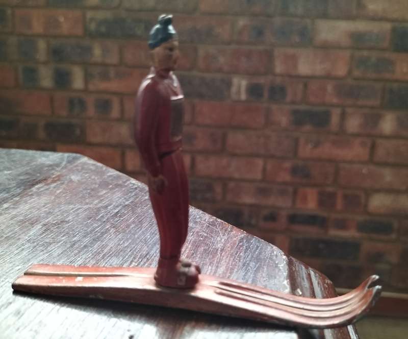 Vintage skier (plastic body, metal skies)