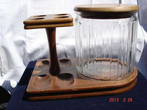 Pipe stand with tobacco jar.