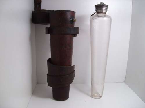 Antique saddle flask glass with leather holder.
