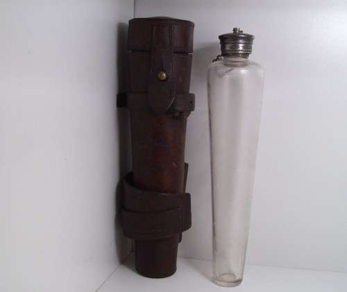 Antique saddle flask glass with leather holder.