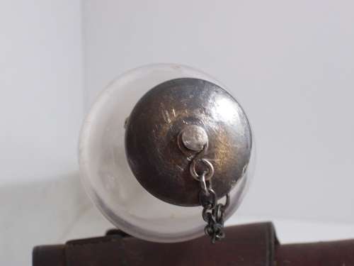 Antique saddle flask glass with leather holder.