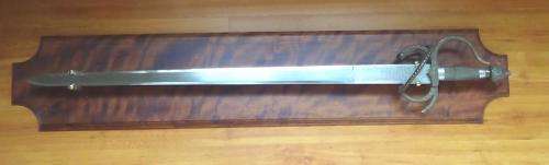 Modern Sword on a heavy  wooden display plinth.