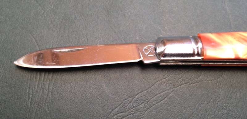 Pocket knife, crossed arrows mark.