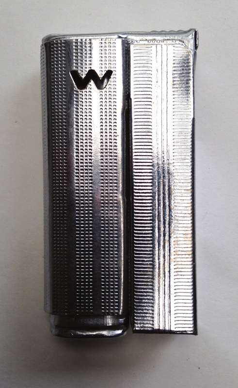 Vintage fluid and flint lighter "W" with removable fuel tank.