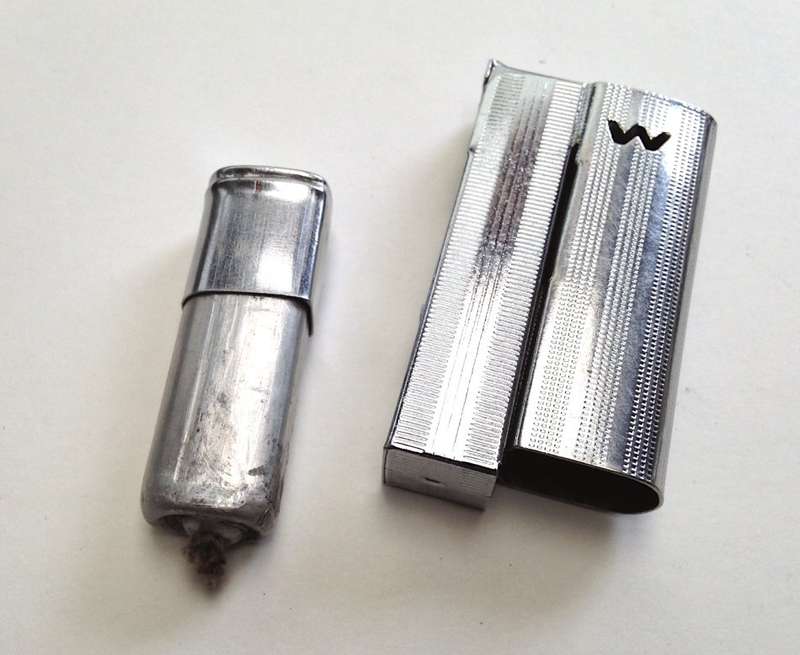 Vintage fluid and flint lighter "W" with removable fuel tank.