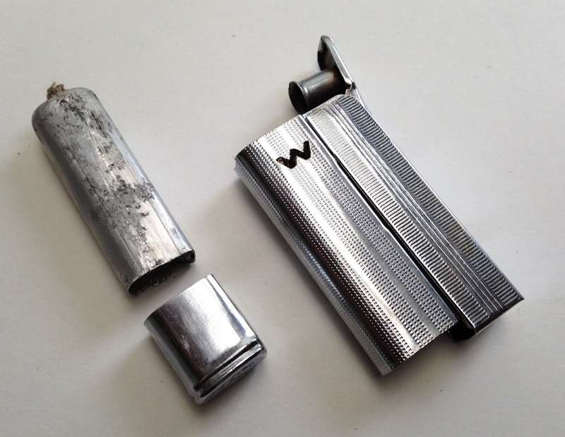 Vintage fluid and flint lighter "W" with removable fuel tank.