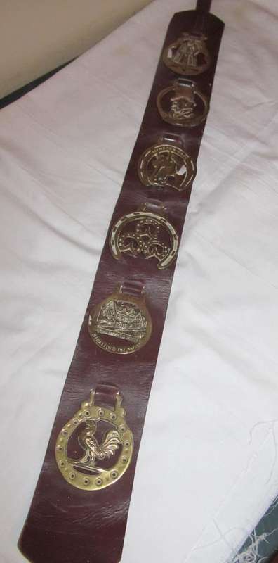 HORSE BRASSES ON A LEATHER BELT