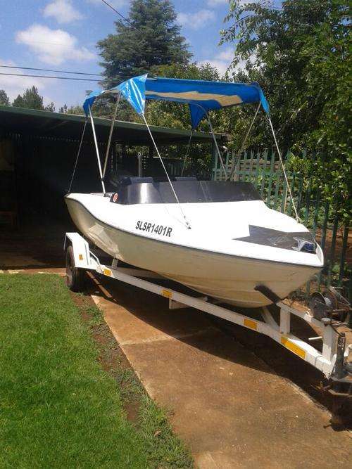 Motor boat with motor and trailer.