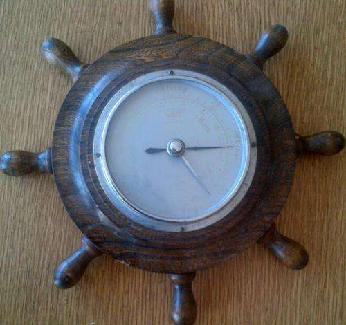 OLD WEATHER GUAGE SET IN A SHIP WHEEL-