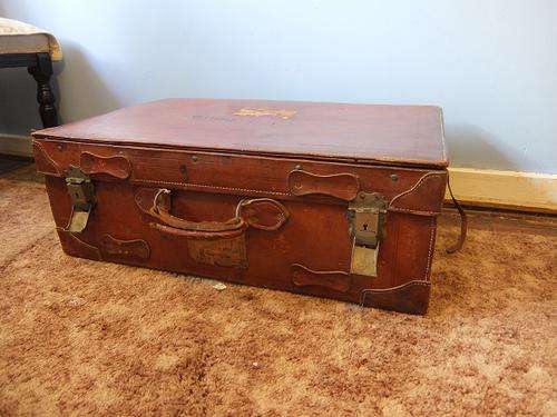 Large brown leather suitcase