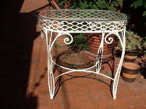 A Small Ornate Wrought Iron Table.