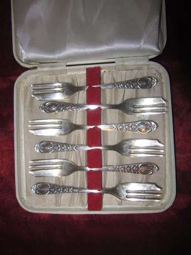 An Ornate Boxed Set of  Six Silver Plated Cake Forks.