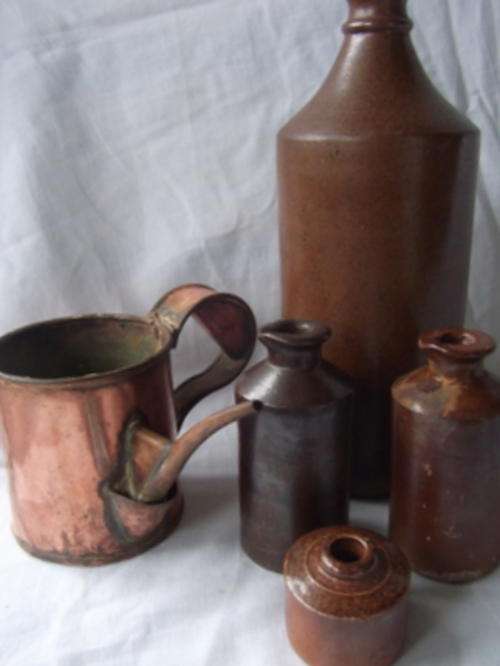 A WONDERFUL COLLECTION OF FOUR ANTIQUE INK BOTTLES AND A COPPER INK POURER