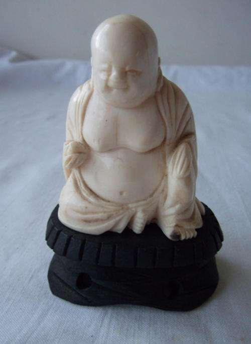 BEAUTIFUL CARVED IVORY BUDDAH ON A WOODEN STAND