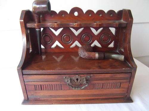 A STUNNING WOODEN PIPE STAND WITH TWO PIPES