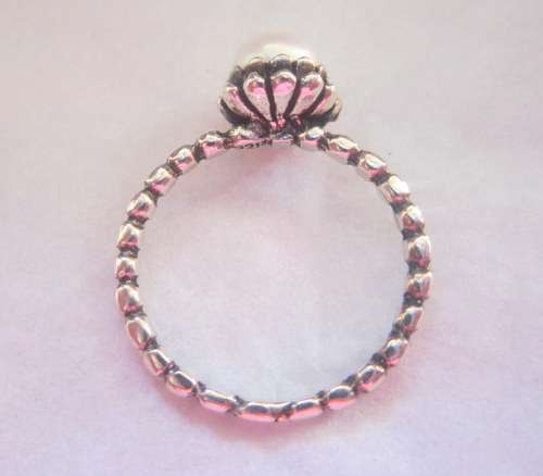 Genuine pearl set in a delightful sterling silver flower crown ring.