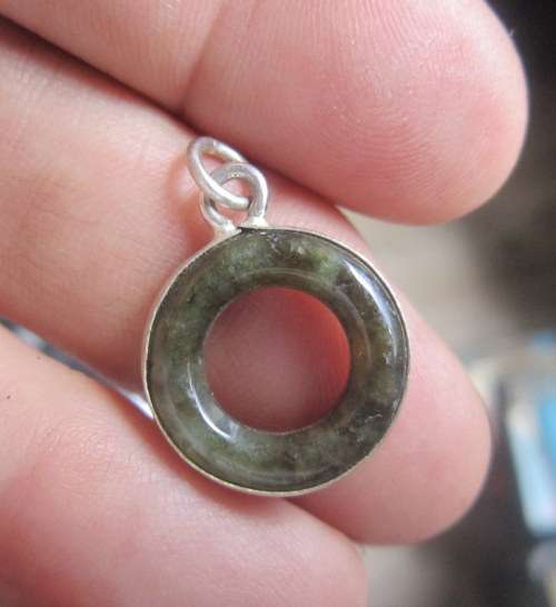 Lovely little Burmese Jade charm or pendant in an unmarked silver casing. 18 mm in diameter
