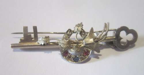 Sentimental 9 carat gold pin. Antique.  Sapphires and rubies set in the lucky horseshoe.