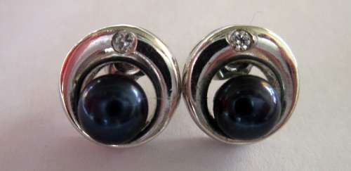 Beautiful sterling silver studs with a charcoal blue natural pearl and accented by a little zirconia