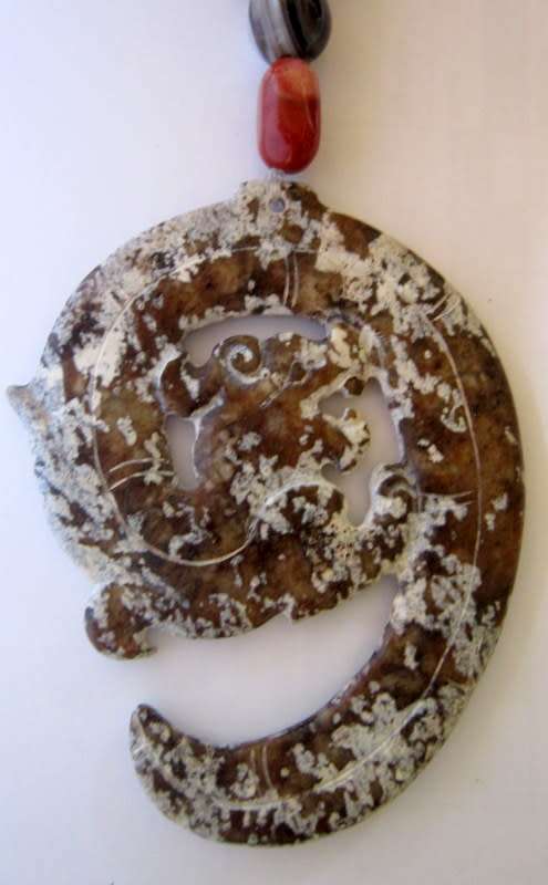 Vintage Oriental necklace. Mottled brown oriental stone pendant with what looks like a dragon spiral