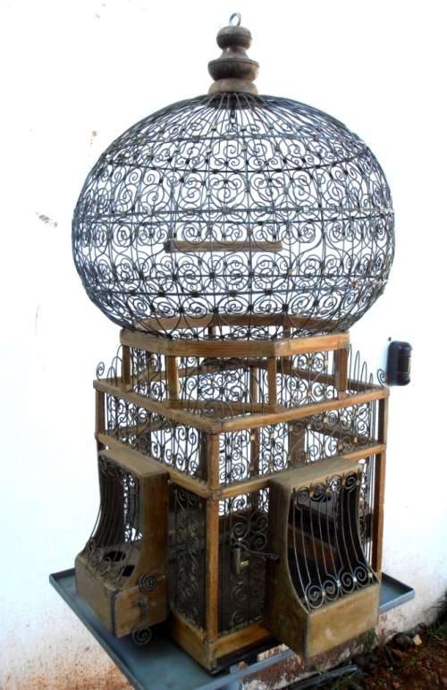 A very ornate and decorative wooden and metal bird cage, canary, finch, budgie