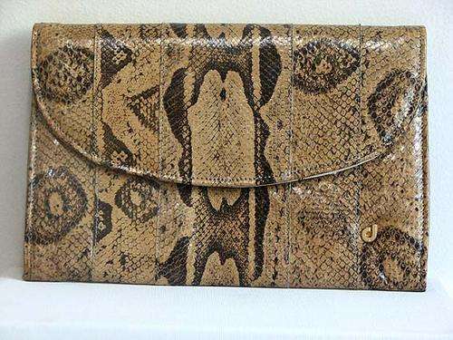 Vintage Authentic Charles Jordaan snakeskin clutch retails for $250 on Ebay