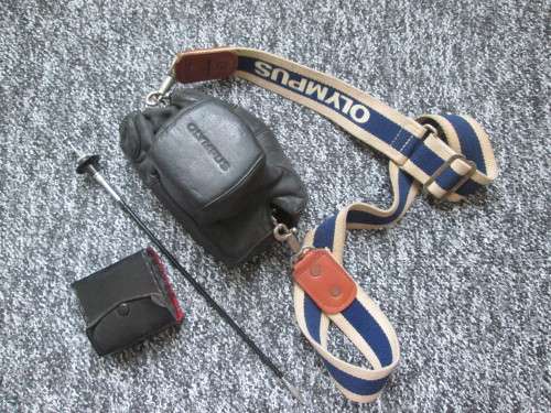 Olympus OM1 SLR, with enlarging rings, cable release, strap, and pouch.