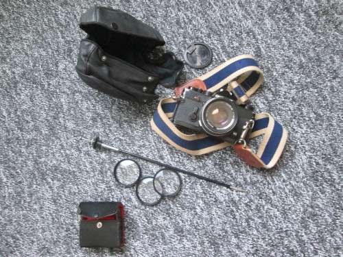 Olympus OM1 SLR, with enlarging rings, cable release, strap, and pouch.