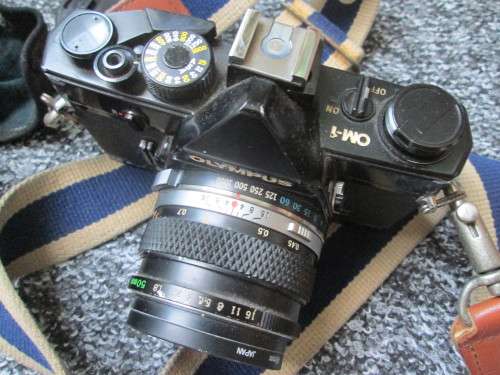 Olympus OM1 SLR, with enlarging rings, cable release, strap, and pouch.