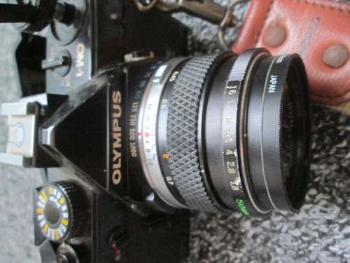 Olympus OM1 SLR, with enlarging rings, cable release, strap, and pouch.