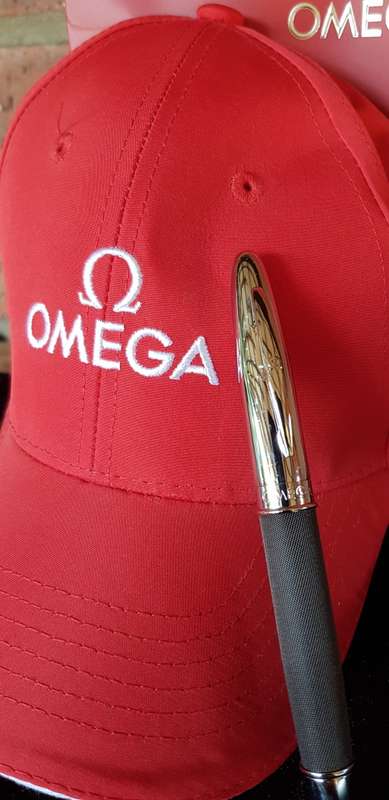BRAND NEW GENUINE OMEGA CAP AND PEN IN GIFT BAG