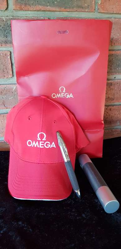 BRAND NEW GENUINE OMEGA CAP AND PEN IN GIFT BAG