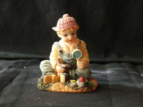 Boy with magnifying glass and book  - ornament