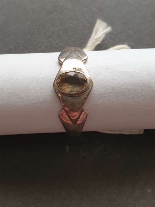 A siver ring with yellow stones cushion cut stone