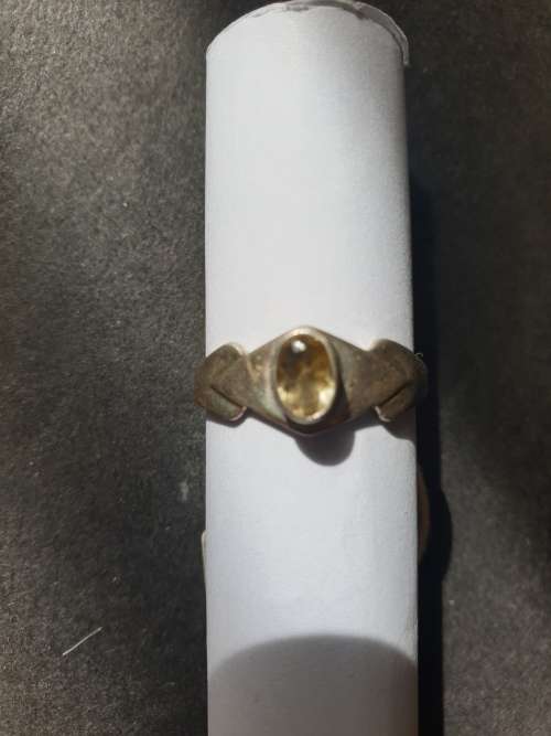 A siver ring with yellow stones cushion cut stone