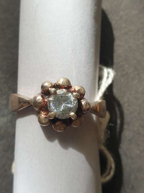 A siver ring with white stones round cut stone