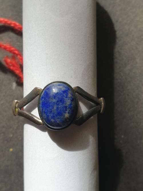 A siver ring with blue stones ovel cut stone