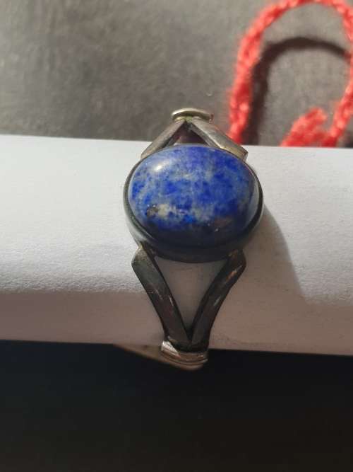 A siver ring with blue stones ovel cut stone