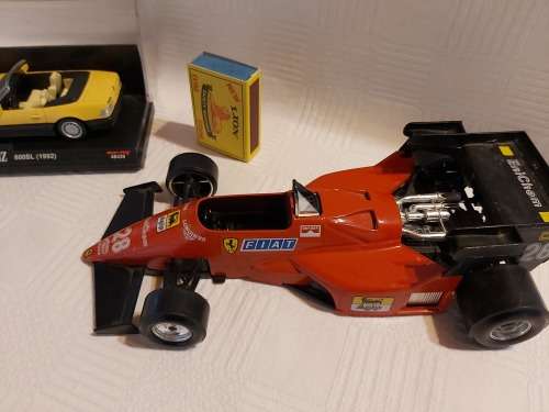 Ferrari racing car (  made in italy ) and one Mercedes benz car (600SL (1992)