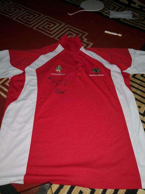 Border rugby player issue and signed golf shirt