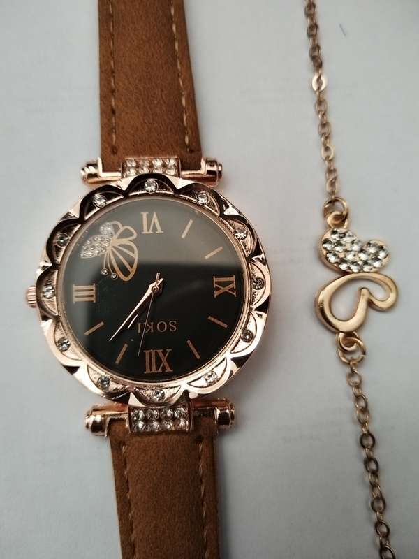 Stunning butterfly bracelet with brown watch.