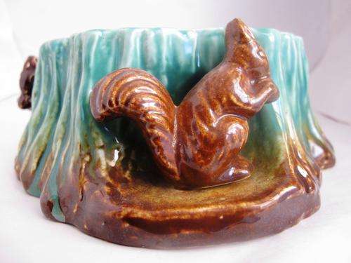 Lucia ware log with squirrel.