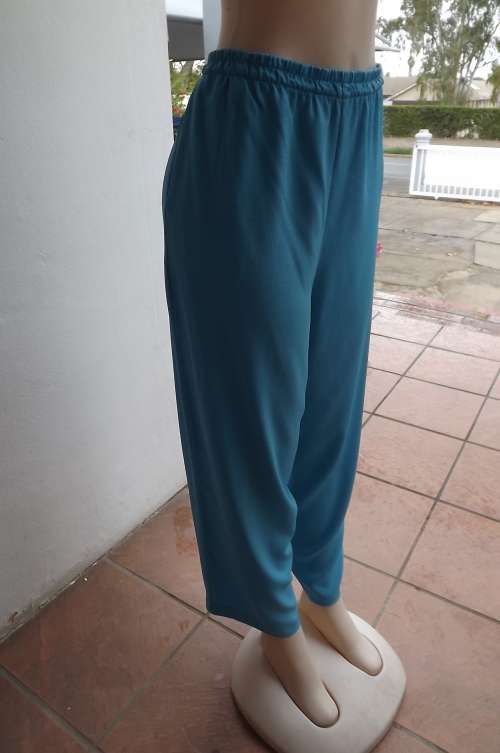 Light blue comfortable light weight pants in size 42/18.In textured wash + wear polyester.