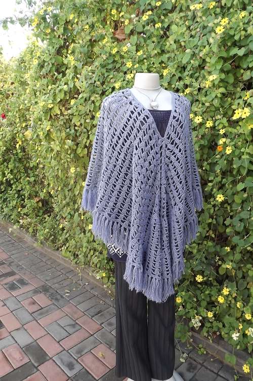 Stunning steel blue knitted poncho with V neckline.Will fit size 36/38 best.Fringed seamline.